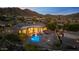Aerial view of stunning home and pool surrounded by mountains at 11986 N 134Th Pl, Scottsdale, AZ 85259