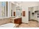 Elegant bathroom featuring a soaking tub, large window, and dark wood cabinets at 11986 N 134Th Pl, Scottsdale, AZ 85259