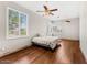 Bedroom with hardwood floors, ceiling fan, plantation shutters, and neutral paint at 11986 N 134Th Pl, Scottsdale, AZ 85259