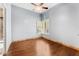 Bedroom with ceiling fan, hardwood floors, and plantation shutters on window at 11986 N 134Th Pl, Scottsdale, AZ 85259