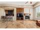 Bright living room with fireplace, a wet bar, and built-in cabinets at 11986 N 134Th Pl, Scottsdale, AZ 85259