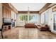 Bright living room with fireplace, two sofas, and large windows with plantation shutters at 11986 N 134Th Pl, Scottsdale, AZ 85259