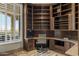 Office with custom built-in bookshelves, desk, and window with outdoor views at 11986 N 134Th Pl, Scottsdale, AZ 85259