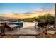 Outdoor pool area with lounge chairs, stone pavers, and warm lighting at 11986 N 134Th Pl, Scottsdale, AZ 85259