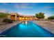 Backyard view of a private pool with water feature and covered patio at 11986 N 134Th Pl, Scottsdale, AZ 85259