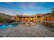 Luxurious pool with stone patio and bar area in the backyard of the home at 11986 N 134Th Pl, Scottsdale, AZ 85259