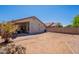 A spacious backyard with gravel, brick patio, and covered patio, perfect for entertaining at 12208 N 41St Ln, Phoenix, AZ 85029