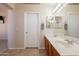 Bathroom with a dual sink vanity, large mirror, and tile flooring at 12208 N 41St Ln, Phoenix, AZ 85029