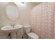 Bathroom featuring a pedestal sink and toilet at 12208 N 41St Ln, Phoenix, AZ 85029