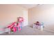 Neutral toned bedroom with gray carpet and a dollhouse at 12208 N 41St Ln, Phoenix, AZ 85029
