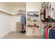 Walk-in closet with built-in shelving and ample storage space for organization at 12208 N 41St Ln, Phoenix, AZ 85029