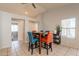 Open-concept dining area with vaulted ceilings and a table with bright-colored chairs at 12208 N 41St Ln, Phoenix, AZ 85029