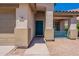 Welcoming front entrance with a vibrant blue door, desert landscaping, and covered porch at 12208 N 41St Ln, Phoenix, AZ 85029