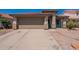 Charming single-story home featuring a two-car garage, cozy front porch, and easy-to-maintain landscaping at 12208 N 41St Ln, Phoenix, AZ 85029