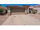 Inviting single-Gathering home with a wide driveway leading to a two-car garage and landscaped front yard at 12208 N 41St Ln, Phoenix, AZ 85029