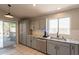 Stylish kitchen with granite countertops, gray cabinetry, and stainless steel dishwasher at 12208 N 41St Ln, Phoenix, AZ 85029