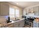 Close-up of kitchen featuring stainless steel appliances and granite countertops at 12208 N 41St Ln, Phoenix, AZ 85029