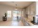Modern kitchen with granite countertops and stainless steel dishwasher with patio access at 12208 N 41St Ln, Phoenix, AZ 85029