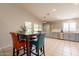 Bright kitchen features modern grey cabinets, stainless steel appliances, tile flooring, and eat in dining area at 12208 N 41St Ln, Phoenix, AZ 85029