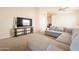 Cozy living room with a large sectional sofa, entertainment center, and comfortable atmosphere at 12208 N 41St Ln, Phoenix, AZ 85029
