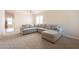 Bright and airy living room featuring a large sectional sofa and plush carpeting at 12208 N 41St Ln, Phoenix, AZ 85029