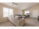 Spacious living room with neutral carpet, ample natural light, and a cozy sectional sofa at 12208 N 41St Ln, Phoenix, AZ 85029