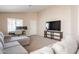 Comfortable living room with neutral tones, workspace, and entertainment center at 12208 N 41St Ln, Phoenix, AZ 85029