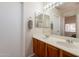 Full bathroom with a dual sink vanity, large mirror, and shower with curtain at 12208 N 41St Ln, Phoenix, AZ 85029