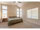 Bright main bedroom featuring neutral carpet, multiple windows, a ceiling fan, and ample natural light at 12208 N 41St Ln, Phoenix, AZ 85029