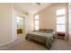 Spacious main bedroom with high ceilings, plush carpet, and bright natural light at 12208 N 41St Ln, Phoenix, AZ 85029