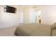 Cozy main bedroom featuring plush carpet, ensuite bathroom, and modern ceiling fan at 12208 N 41St Ln, Phoenix, AZ 85029