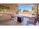 A covered patio with outdoor seating and a view of the backyard at 12208 N 41St Ln, Phoenix, AZ 85029