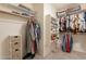 Spacious walk-in closet featuring custom shelving and ample storage space at 12208 N 41St Ln, Phoenix, AZ 85029