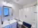Bathroom features a tub and shower with a patterned curtain and a vanity sink at 12934 W Voltaire Ave, El Mirage, AZ 85335