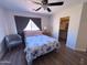 Bedroom with wood floors, a ceiling fan, and a walk in closet for ample storage at 12934 W Voltaire Ave, El Mirage, AZ 85335