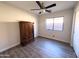 Simple bedroom showcasing wood-style flooring, window view, and an open area for furniture arrangement at 12934 W Voltaire Ave, El Mirage, AZ 85335