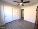 Another bedroom showing wooden flooring, closet and door at 12934 W Voltaire Ave, El Mirage, AZ 85335