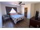 Bedroom with wood floors, a ceiling fan, and a walk-in closet at 12934 W Voltaire Ave, El Mirage, AZ 85335