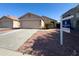 Inviting home featuring a well-maintained front yard, two-car garage, and professional real estate signage at 12934 W Voltaire Ave, El Mirage, AZ 85335
