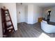 The home's foyer features wood-look floors, fresh paint, and a decorative wood shelf at 12934 W Voltaire Ave, El Mirage, AZ 85335