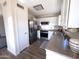 Modern kitchen featuring stainless steel appliances, white cabinets, and a spacious layout perfect for cooking at 12934 W Voltaire Ave, El Mirage, AZ 85335