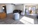 Cozy living space with wood-look floors, neutral walls, and an open layout for entertaining at 12934 W Voltaire Ave, El Mirage, AZ 85335