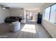 Inviting living area with wood-look floors, neutral decor, and seamless access to the dining area at 12934 W Voltaire Ave, El Mirage, AZ 85335