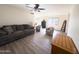 Open-concept living space featuring wood-look floors, fresh paint, and comfortable seating at 12934 W Voltaire Ave, El Mirage, AZ 85335