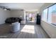 Spacious living room with wood-look floors, stylish furniture, and plenty of natural light at 12934 W Voltaire Ave, El Mirage, AZ 85335
