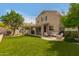 Backyard with synthetic grass, a playground, a covered patio, and seating creating an ideal outdoor space for entertaining at 13993 N 102Nd St, Scottsdale, AZ 85260