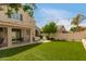 Spacious backyard with synthetic grass, a covered patio, and comfortable seating, perfect for outdoor living and gatherings at 13993 N 102Nd St, Scottsdale, AZ 85260