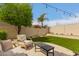 Serene backyard featuring well-maintained synthetic grass, ambient string lights and comfortable outdoor seating at 13993 N 102Nd St, Scottsdale, AZ 85260