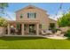 Expansive backyard with a covered patio, lush synthetic grass, and outdoor seating, ideal for entertaining and relaxation at 13993 N 102Nd St, Scottsdale, AZ 85260