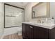 Modern bathroom with a white-tiled shower, dark cabinets, white countertop, and bronze hardware fixtures at 13993 N 102Nd St, Scottsdale, AZ 85260
